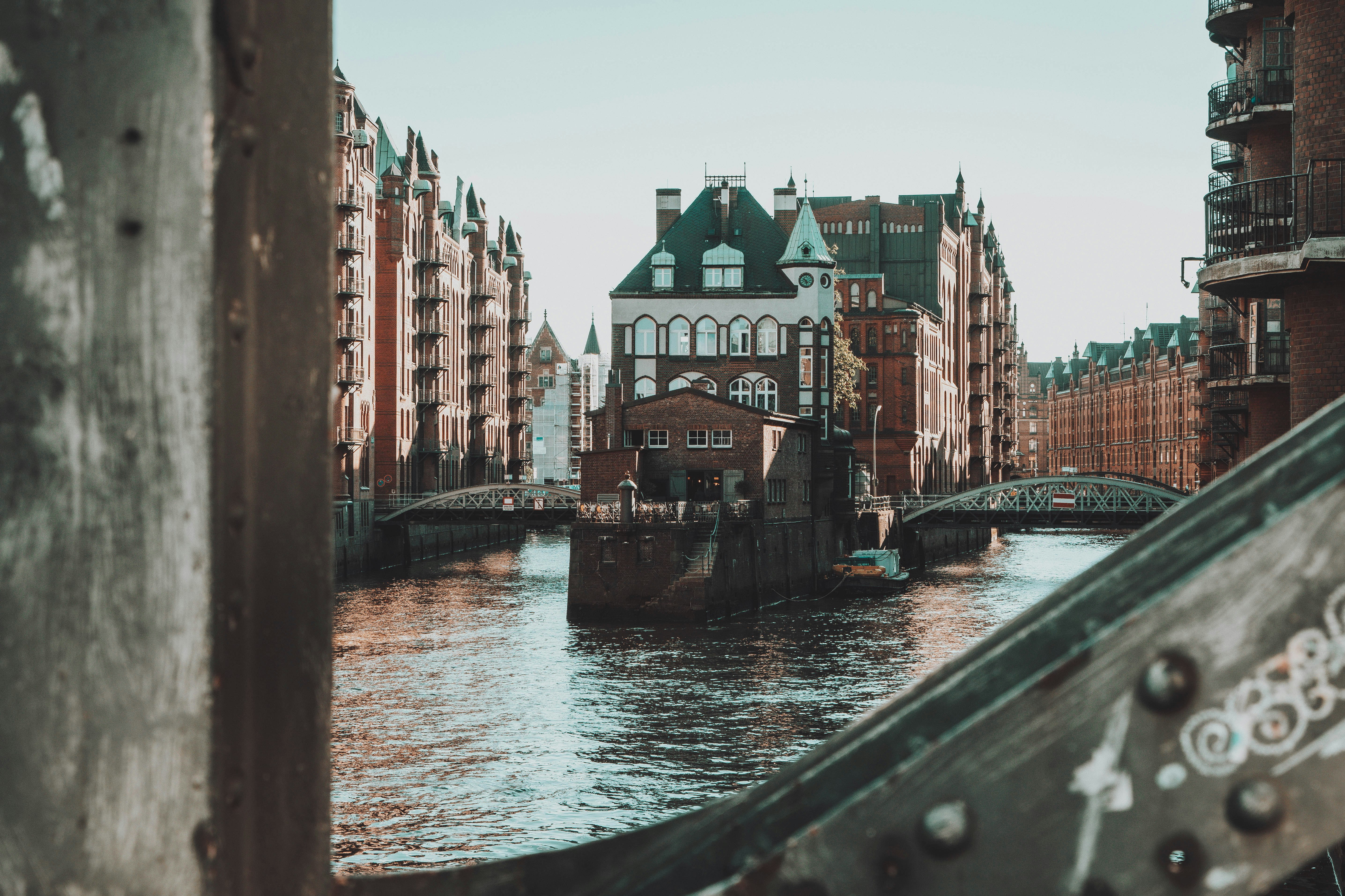 river between concrete buildings during daytime